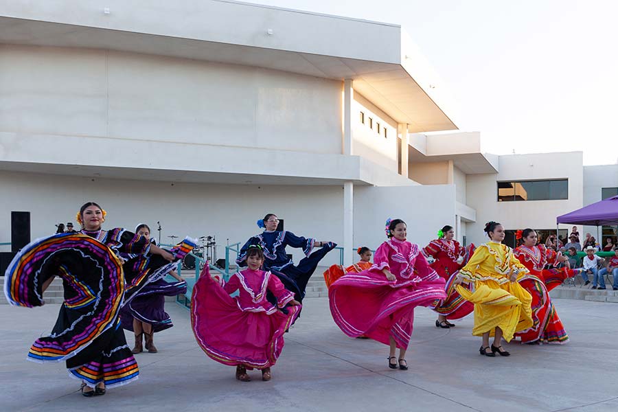 Traditionl dancers perform in colorful dresses during Hispanic Heritage celebration at San Juan College, an emerging HSI.