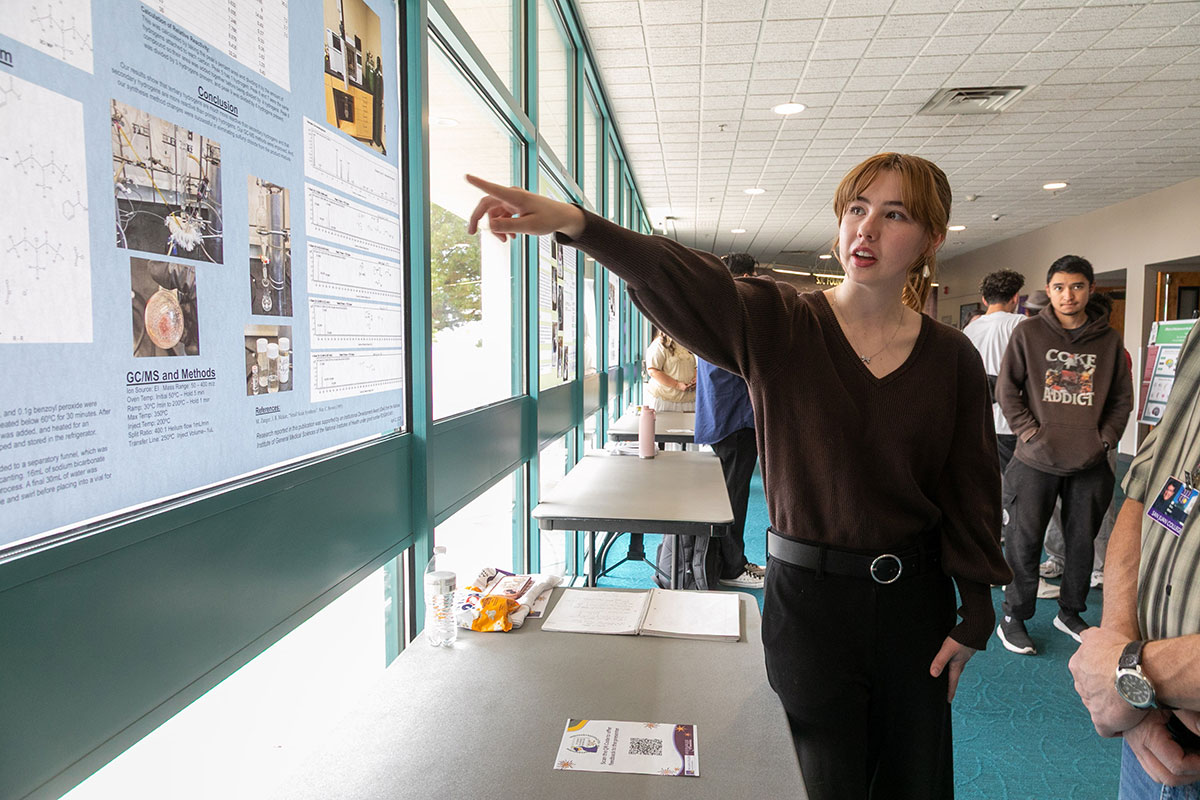 Student explaining their project on the San Juan College main campus during the Student Showcase event.