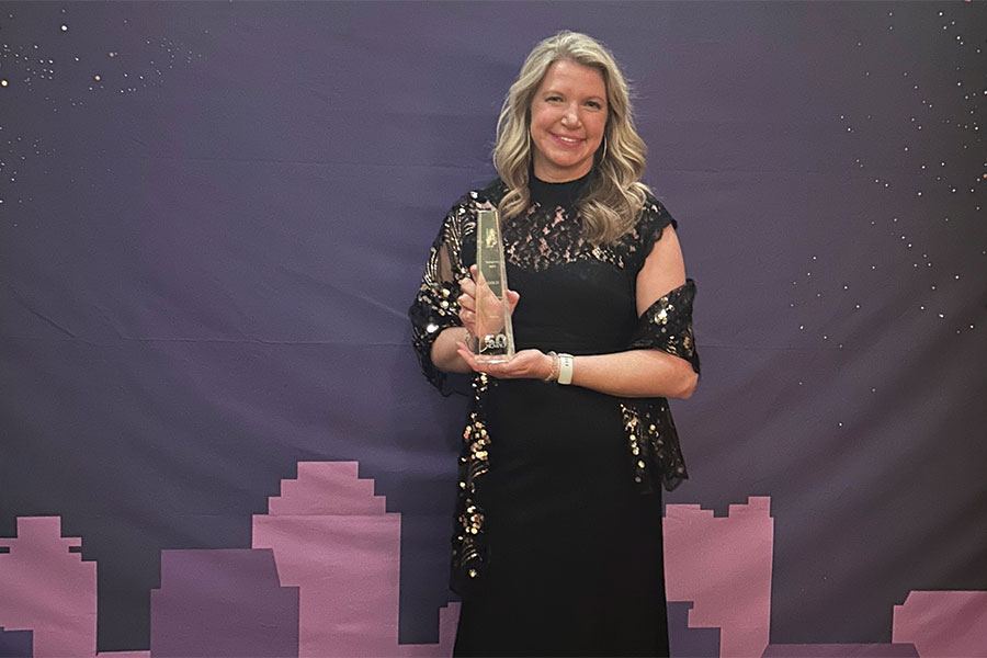 Brandie Solomon holding the Gold AMA Award