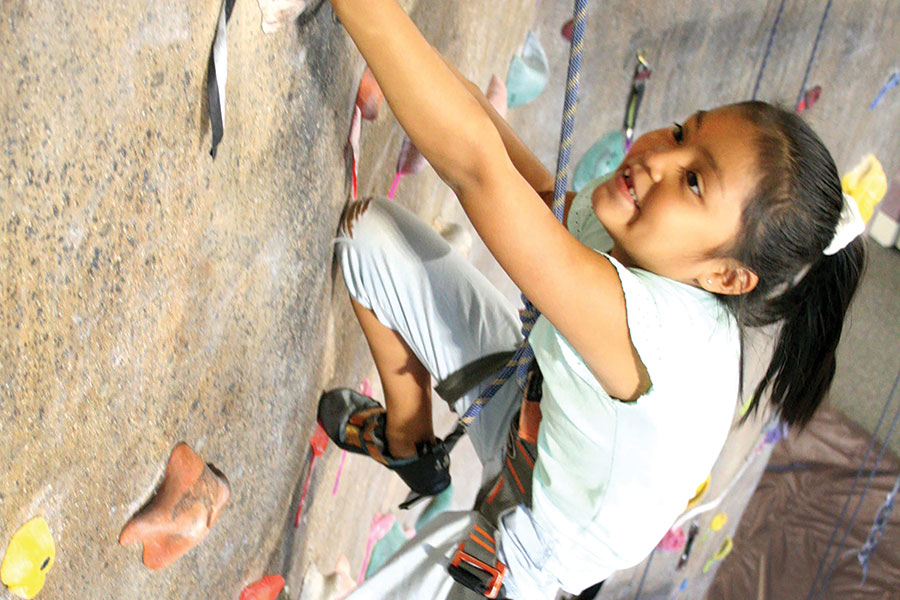 A girl at the HHPC Climbing Wall.