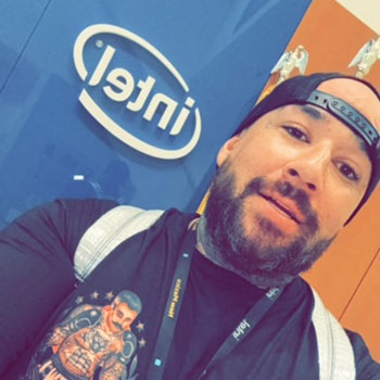 Kevin Chavez in front of the Intel signage